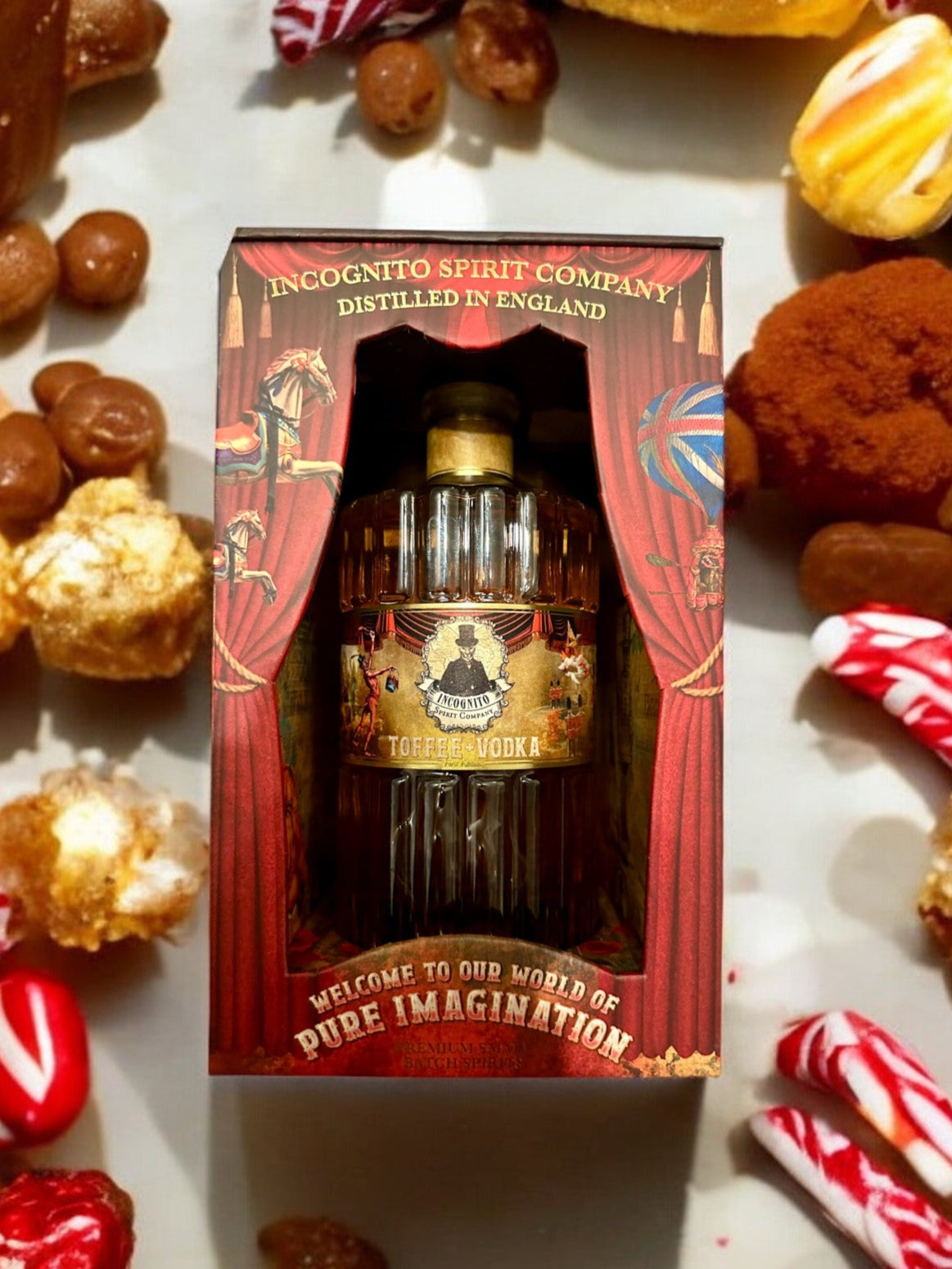 Incognito Toffee Vodka in a premium illustrated gift box, surrounded by sweets and toffee