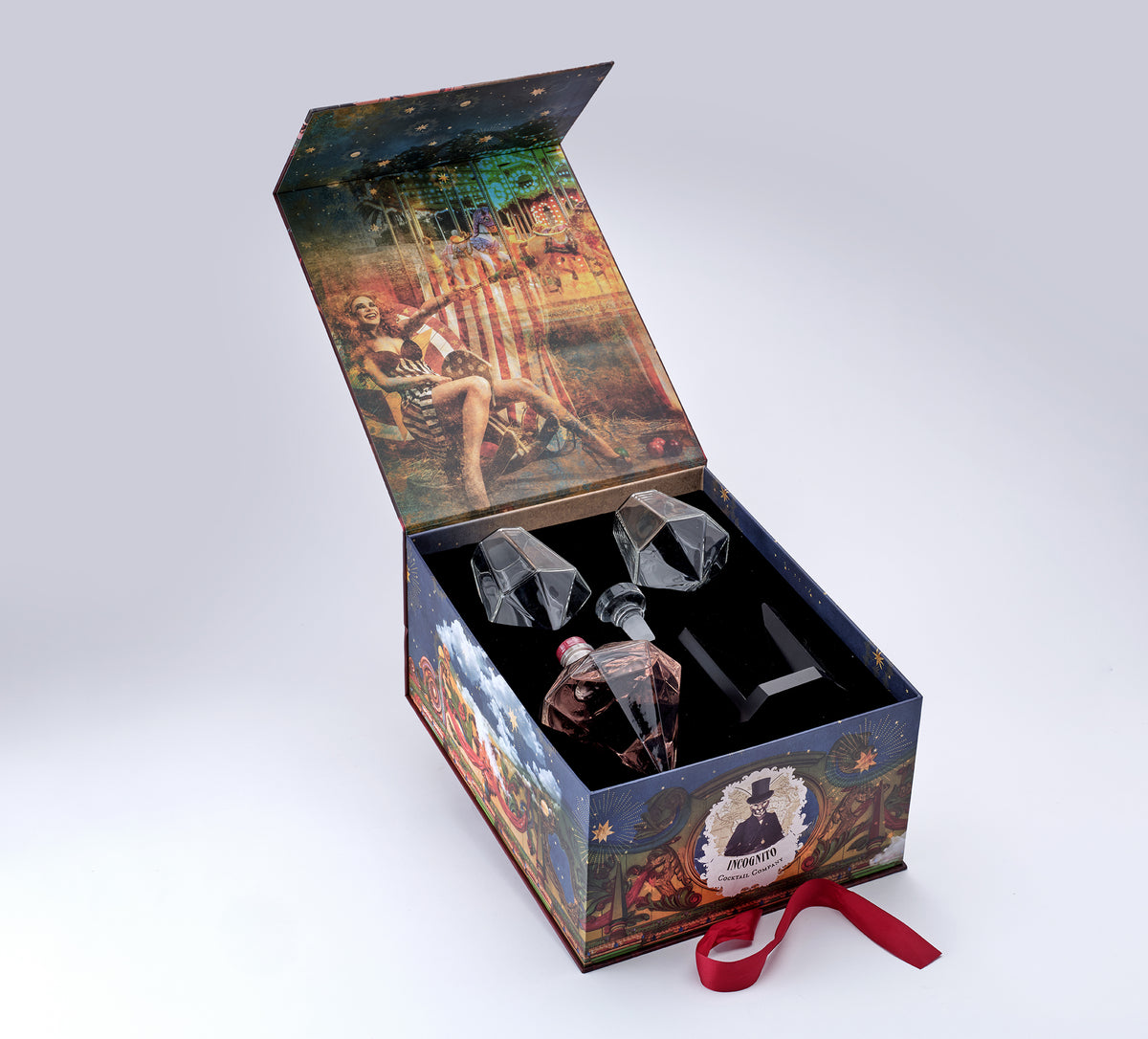 Incognito Pink Star luxury decanter gift set with diamond-shaped decanter and two diamond glasses, presented in a premium illustrated gift box with luxury gift bag.